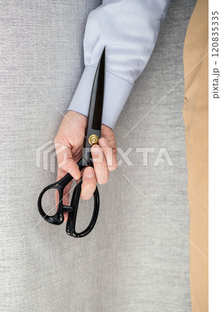 male hand holding scissors male hand holding scissors 120835335