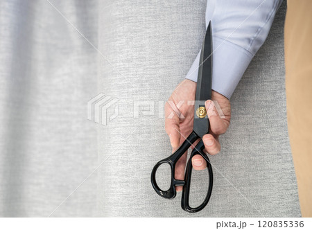 Hand in shirt holding scissors. Hand in shirt holding scissors. 120835336