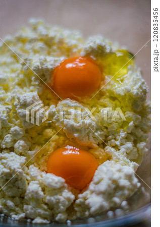Fresh eggs and cottage cheese close-up for cooking or baking ingredients. High quality photo Fresh eggs and cottage cheese close-up for cooking or baking ingredients. High quality photo 120835456