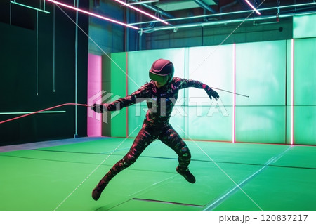 A woman in a black and white outfit is jumping in the air with a red rope 120837217