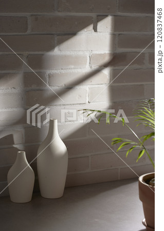 Various objects and vintage brick background with shadows of sunlight coming through the window. Various objects and vintage brick background with shadows of sunlight coming through the window. 120837468