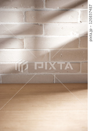 Various objects and vintage brick background with shadows of sunlight coming through the window. 120837487