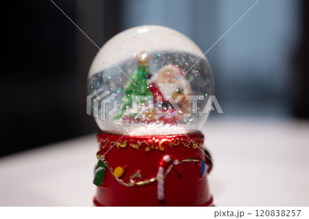A festive Snow Globe featuring Santa and a Christmas Tree, embodying the holiday spirit A festive Snow Globe featuring Santa and a Christmas Tree, embodying the holiday spirit 120838257