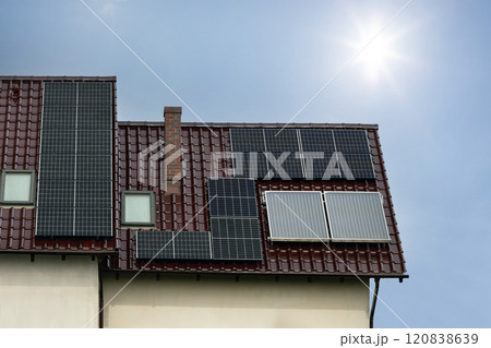 House Roof with Solar Panels Under Sunny Sky 120838639