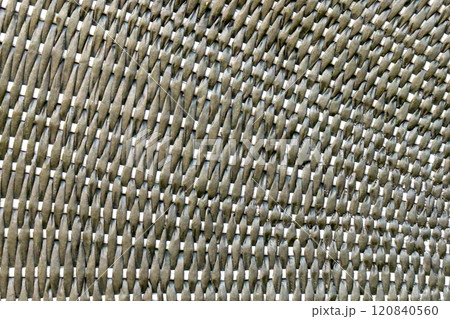 Close-up of woven straw texture with intricate interlocking patterns as a green abstract background 120840560