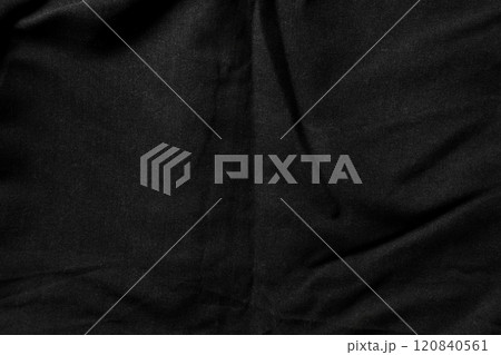 Close-up of black fabric with subtle folds and a soft dusty matte texture. Minimalist abstract backgrounds or textile design. Top view shot 120840561