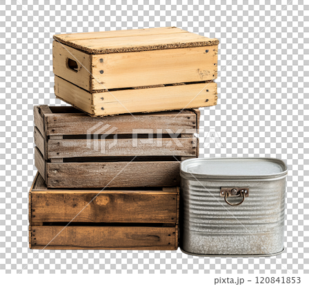 A stack of rustic wooden crates, in varying sizes and shades, sits beside a vintage metal container. 120841853