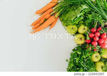 carrots, green vegetables, apples and radishes on a white background 120841897