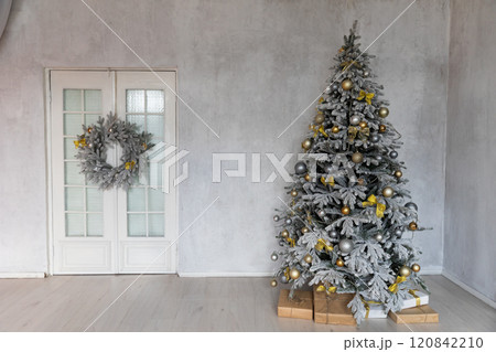 snow Christmas tree with gifts decorated with garlands in the interior for the new year 120842210