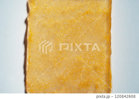 Gold gel rectangle smear closeup on white background Gold gel rectangle smear closeup on white background 120842608
