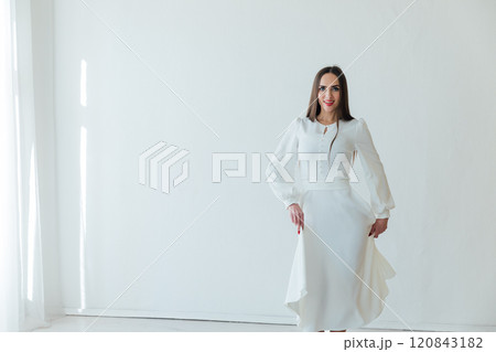Portrait of a beautiful slender fashionable woman in a white summer dress 120843182