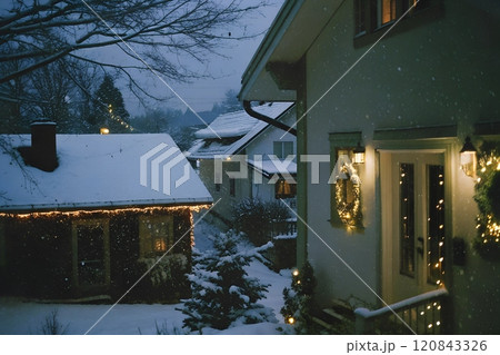 Snow covered houses in the village with christmas decorations 120843326