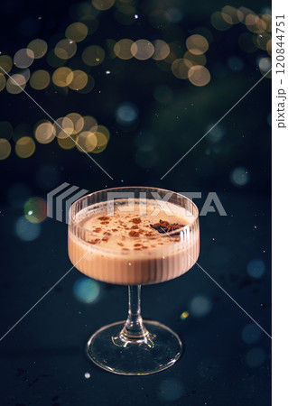 Eggnog cocktail decorated with star anise 120844751