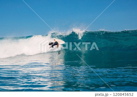Surfer woman fell off a ocean blue wave. Surf girl wipe out during surfing 120845652
