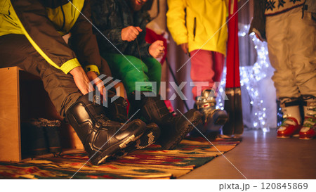 Close-up shot of ski boots being adjusted, showing vibrant colors and textures, highlighting the excitement of cozy pre-ski preparation scene. Close-up shot of ski boots being adjusted, showing vibrant colors and textures, highlighting the excitement of cozy pre-ski preparation scene. 120845869