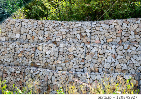 Stone gabion wall structure in nature. Stone gabion wall structure in nature. 120845927