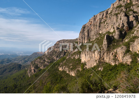 a majestic rock against the blue sky 120845978