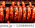 Sausage production line showing smoked sausages hanging in a modern food processing plant 120846092