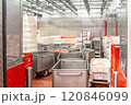 Meat processing plant storing pork cuts in metal containers 120846099
