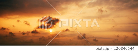 Panorama with an orange sunset and sun in a cloudy sky with clouds. Background with sky at sunrise 120846544