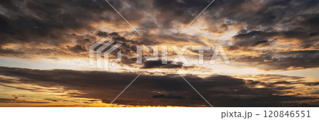 orange sunset in cloudy sky with clouds at sunset in the evening. Panoramic background with sky 120846551