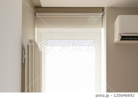 Roller blinds double system on the window. Blackout shade and sunscreen curtain. Motorized roller blinds for smart house. The screen fabric softly diffuses sunlight. Close-up, detailed photo. Roller blinds double system on the window. Blackout shade and sunscreen curtain. Motorized roller blinds for smart house. The screen fabric softly diffuses sunlight. Close-up, detailed photo. 120846692