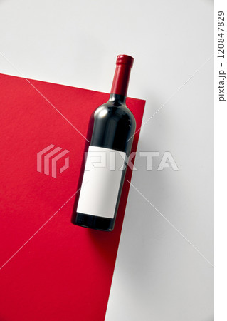Red wine bottle mockup with white label placed against red and white background. Negative space for to insert text, brand name. Red wine bottle mockup with white label placed against red and white background. Negative space for to insert text, brand name. 120847829