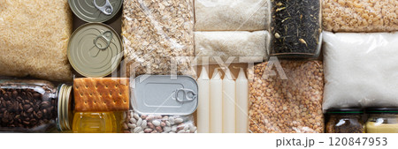 Home food supplies for quarantine and isolation, including canned food, cereals, pasta, and essential staples for survival, survival during military operations, the concept of stay at home, banner 120847953