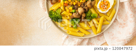 Pasta with fried mushrooms and broccoli, green peas and corn, fresh mix salad Pasta with fried mushrooms and broccoli, green peas and corn, fresh mix salad 120847972