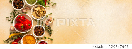 A warm display of spices and herbs on a beige background, each adding rich aromas and flavors, perfect for enhancing recipes, banner A warm display of spices and herbs on a beige background, each adding rich aromas and flavors, perfect for enhancing recipes, banner 120847998