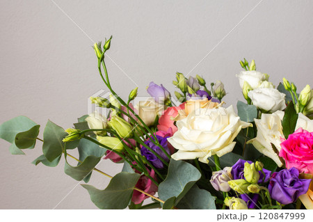 Celebrate special occasions with a colorful summer bouquet featuring fresh roses, eucalyptus, and eustoma blooms, creating an elegant and fragrant floral arrangement 120847999