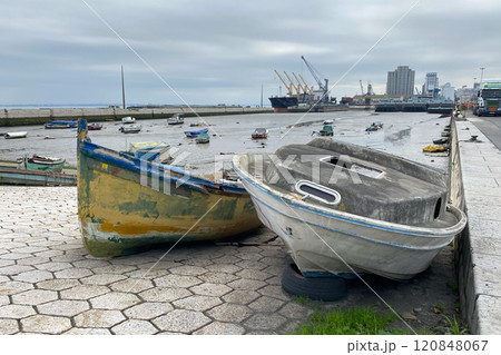 Old ruined wooden boat on the shore near the water 120848067