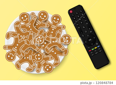 Modern smart TV remote control with Christmas gingerbread cookies 120848784