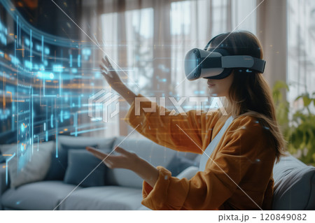 Woman Interacting with Holographic Display Using VR Headset Woman Interacting with Holographic Display Using VR Headset 120849082