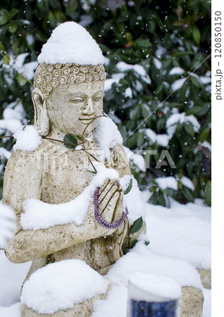 Buddha statue under the snow in winter. 120850150