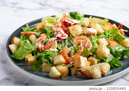 Caesar salad, with shrimp, on a marble background, top view, no people, Caesar salad, with shrimp, on a marble background, top view, no people, 120850440