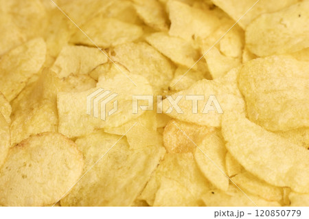 Textured background of crispy potato chips, ideal for design and branding purposes 120850779