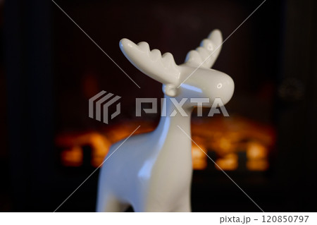 A Stylish White Moose Figurine Perfectly Positioned Against a Beautifully Cozy Background 120850797