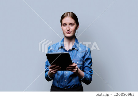 Teenager student girl with digital tablet on grey studio background 120850963