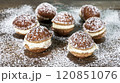 Chocolate pastries filled with creamy frosting are scattered on a rustic wooden surface and topped with powdered sugar. 120851076