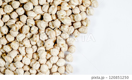 Chickpeas spread across a white surface showcasing their unique texture and shape in a natural light setting 120851250