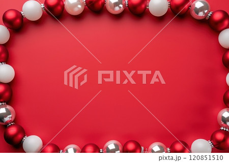 Flat lay of empty red New Year background with red and white balls, Christmas frame or greeting card, top view of festive surface with place for text 120851510