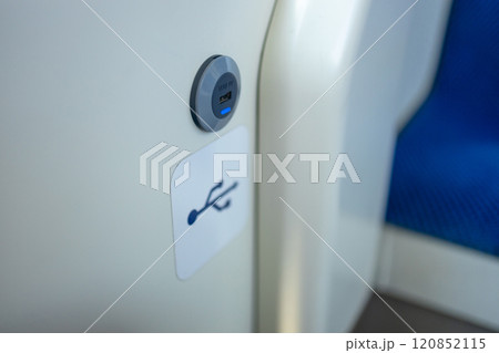 modern bus interior of passenger cabin with gadget USB charging port on handrail. Inside of city coach details. Mobile device charging station in public transport. Closeup view of power inlet 120852115
