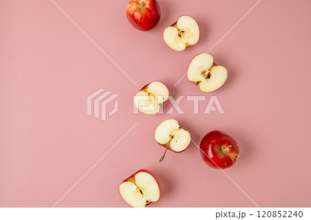 Red apple, half apple and quarter apple on pink background. Top view, healthy food concept. Top view. Red apple, half apple and quarter apple on pink background. Top view, healthy food concept. Top view. 120852240