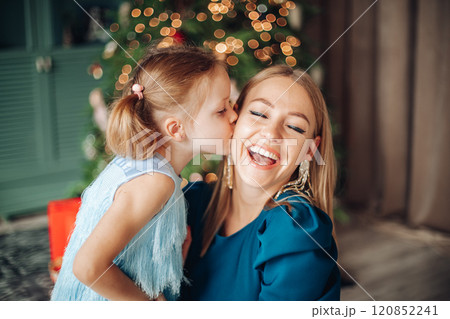 Little girl and her mom on Christmas morning at 120852241