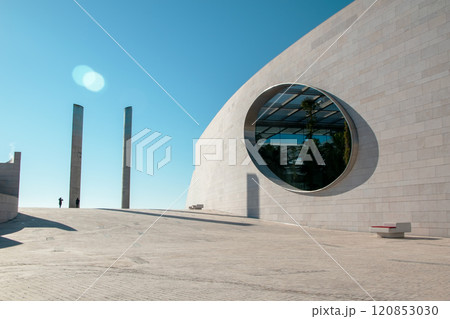 Futuristic landscape, Modern building architecture in the Champalimaud Foundation, oval windows in the wall leading to a garden with palm trees Futuristic landscape, Modern building architecture in the Champalimaud Foundation, oval windows in the wall leading to a garden with palm trees 120853030
