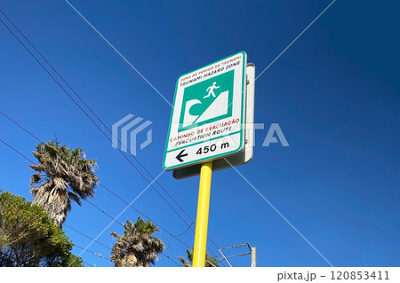 Tsunami evacuation sign on the coast of the Atlantic Ocean in Portugal 120853411