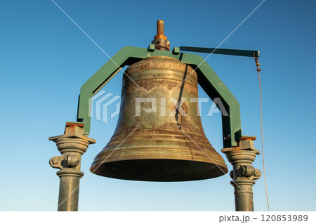 Big old bronze bell against the blue sky 120853989