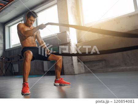 A Dynamic Battle Rope Workout boosts arm strength, core stability, and overall fitness 120854081