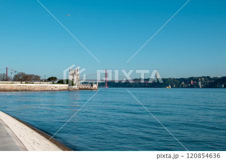 View of Tower of Belem and Ponte 25 de Abril Bridge at sunset, Lisbon, Portugal on the Tagus River View of Tower of Belem and Ponte 25 de Abril Bridge at sunset, Lisbon, Portugal on the Tagus River 120854636